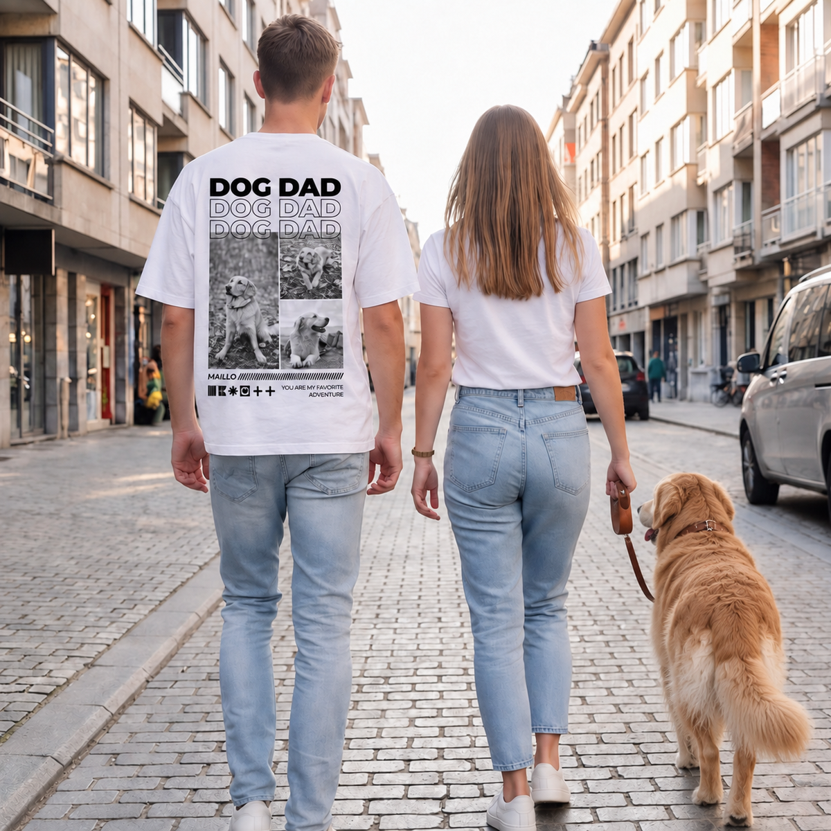 Personen gehen mit Hund auf einer Straße, einer trägt ein weißes T-Shirt mit "DOG DAD"-Motiv.