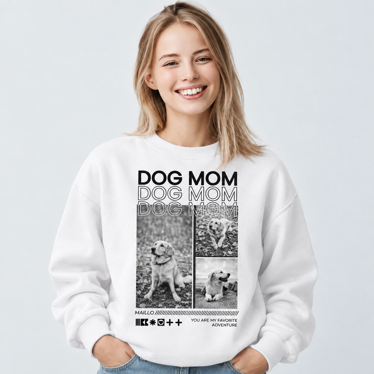 Weißes Sweatshirt mit "DOG MOM"-Print und Bildern von Hunden. Trägerin lächelt direkt in die Kamera.
