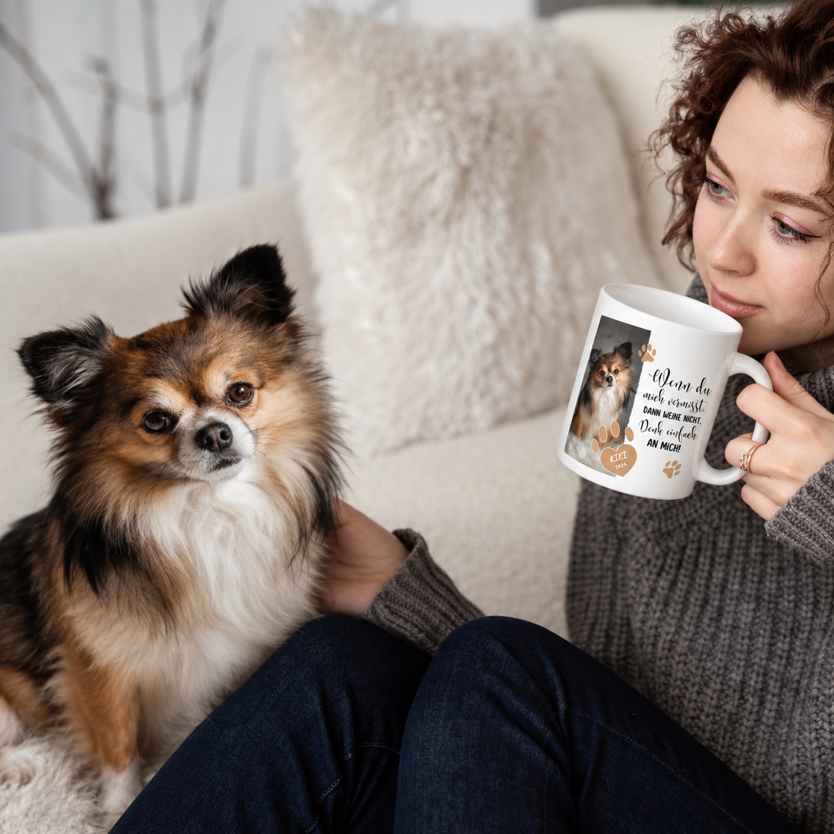 Personalisierte Tasse mit Hundemotiv und Schriftzug, gehalten von einer Person mit grauem Pullover.