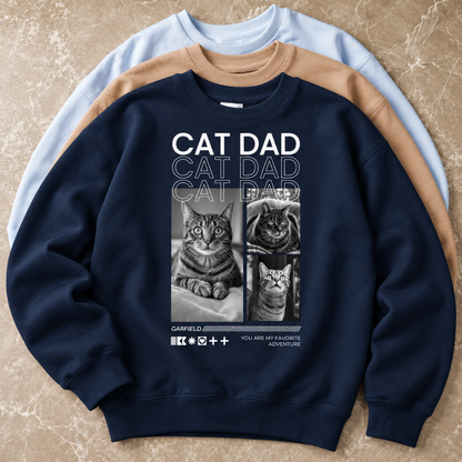 Dunkelblaues Sweatshirt mit Katzenmotiven und „Cat Dad“-Schriftzug auf der Vorderseite.
