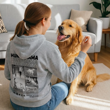 Grauer Hoodie mit "Hundemama"-Aufdruck, Trägerin sitzt mit goldenem Retriever auf Teppich.