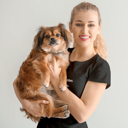 Frau hält einen kleinen Hund in den Armen, trägt ein personalisiertes schwarzes T-Shirt.